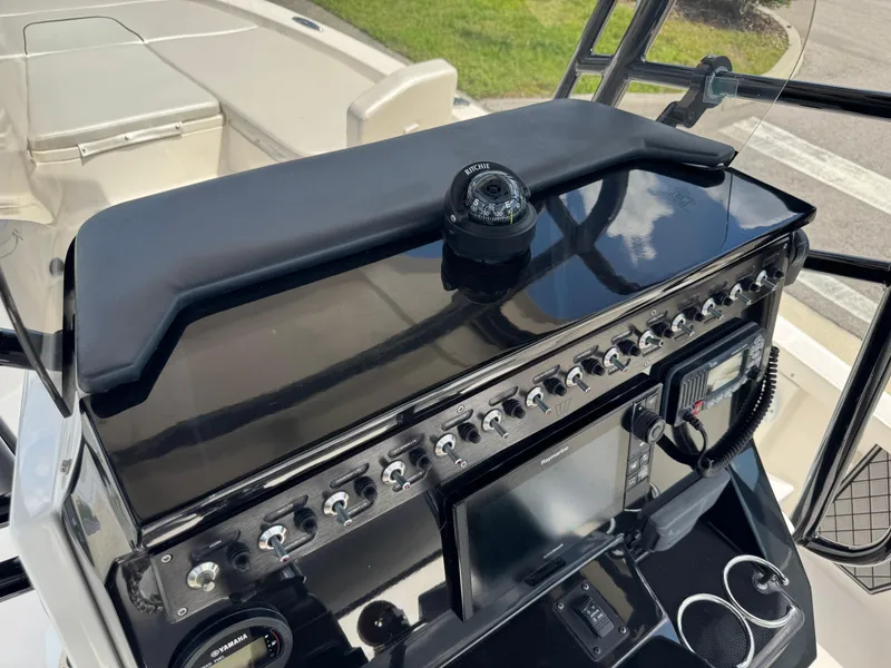 Slide: The Image of Control panel of a 2016 Wellcraft 241 boat with navigation instruments and switches. - 33