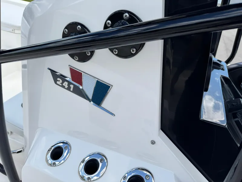 Slide: The Image of 2016 Wellcraft 241 boat dashboard with logo and control panel. - 36