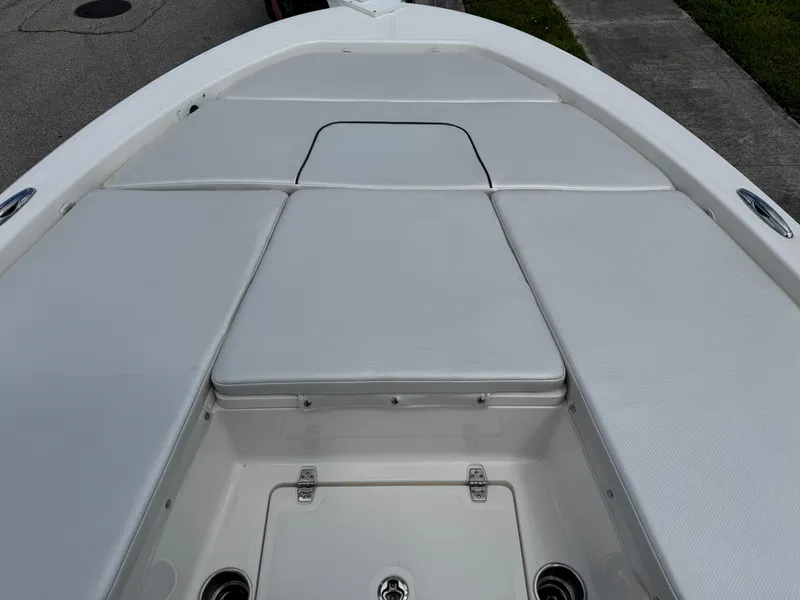 Slide: The Image of 2016 Wellcraft 241 boat deck with cushioned seating and storage compartments. - 37