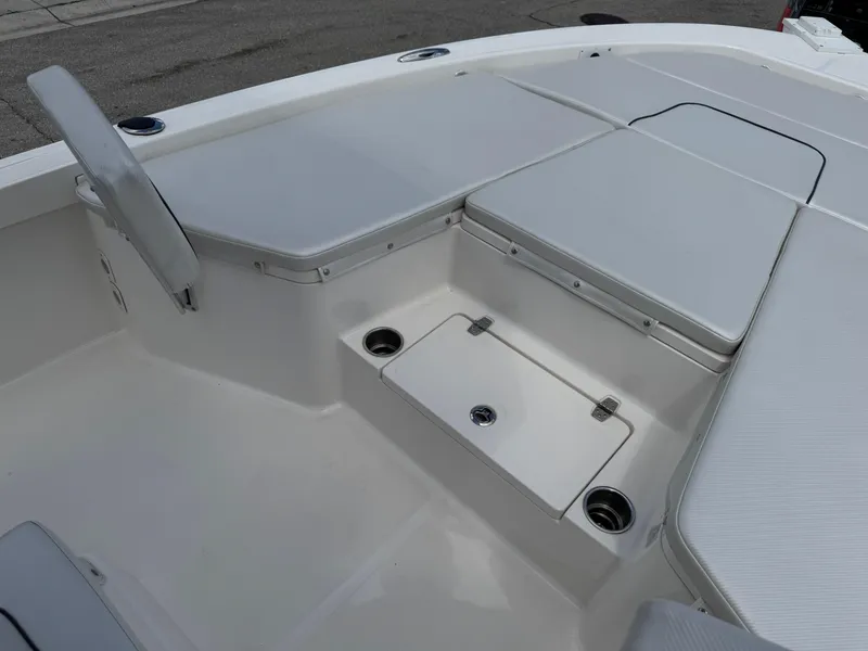 Slide: The Image of 2016 Wellcraft 241 boat interior with cushioned seating and storage compartments. - 38