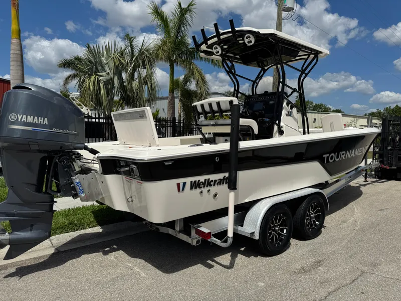 Slide: The Image of 2016 Wellcraft 241 boat with Yamaha engine, parked on a trailer, under a sunny sky. - 4