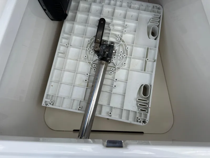 Slide: The Image of 2016 Wellcraft 241 boat compartment with a metal handle and plastic base. - 42