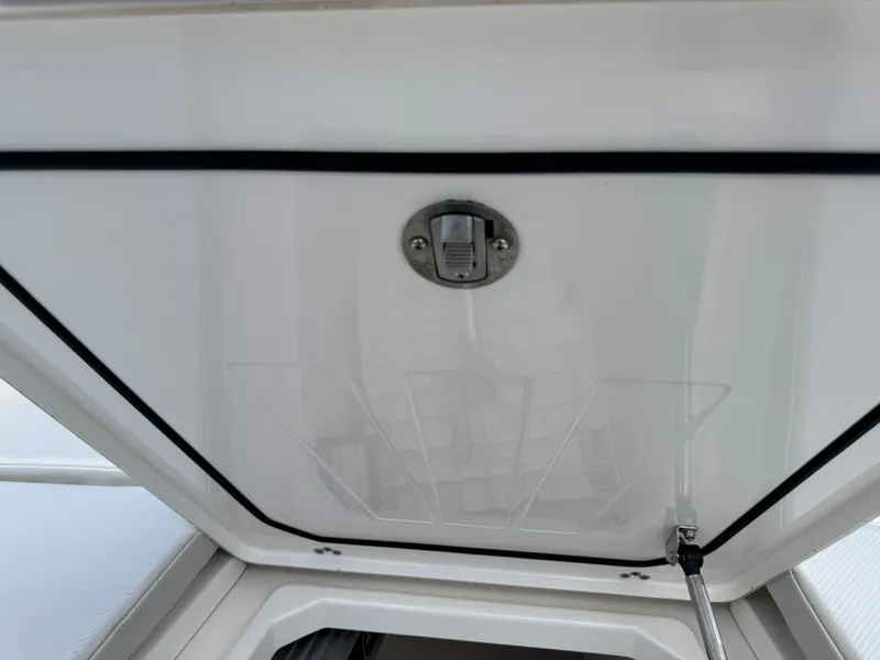 Slide: The Image of 2016 Wellcraft 241 boat hatch interior with latch and support strut. - 43