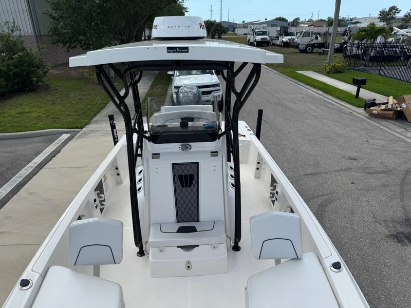 Slide: The Image of 2016 Wellcraft 241 boat with T-top, parked on a street, showcasing spacious deck layout. - 46