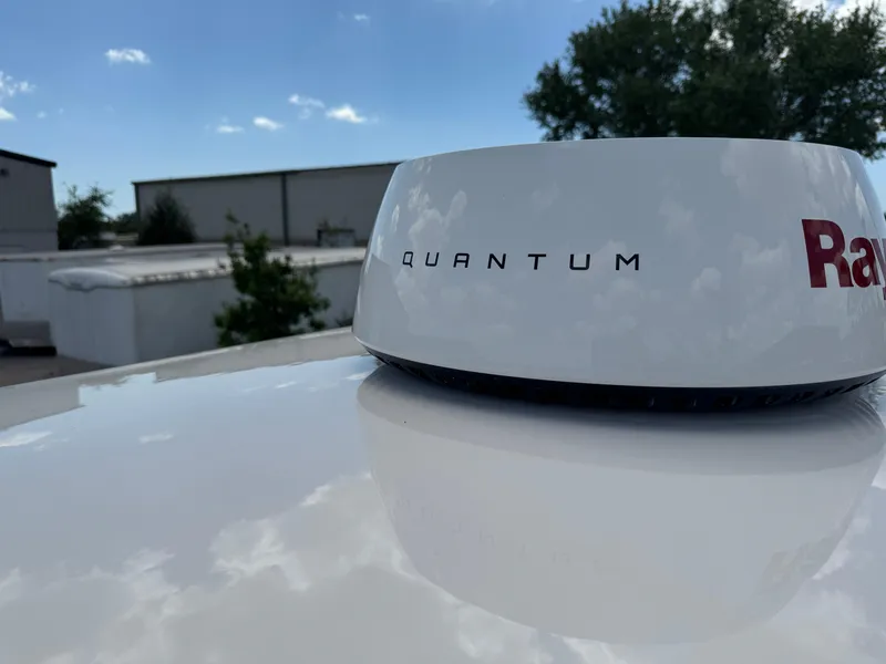 Slide: The Image of Radar dome on 2016 Wellcraft 241 boat under clear blue sky. - 49