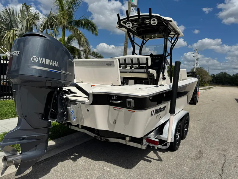 Slide: The Image of 2016 Wellcraft 241 boat with Yamaha engine on trailer, parked under palm trees. - 5