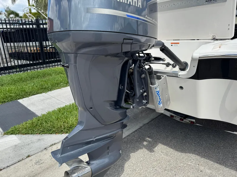 Slide: The Image of Outboard motor on a 2016 Wellcraft 241 boat, parked on a sunny street. - 9