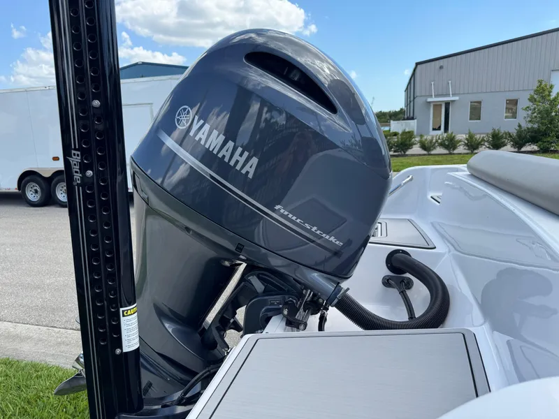 Slide: The Image of 2023 Sportsman Open 212 Center Console with Yamaha outboard motor, parked outdoors. - 17