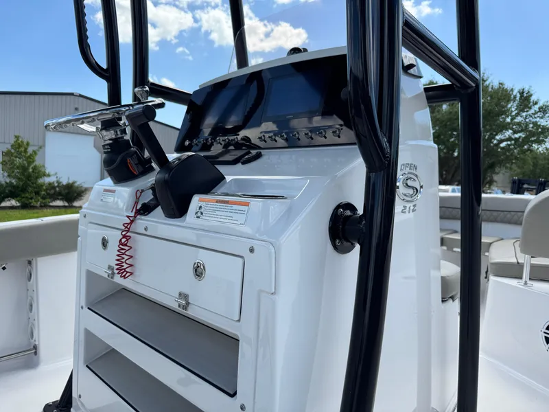 Slide: The Image of 2023 Sportsman Open 212 Center Console boat dashboard with modern controls and storage. - 20