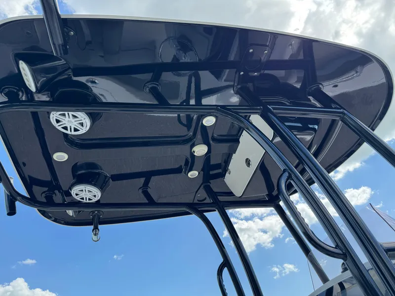 Slide: The Image of 2023 Sportsman Open 212 Center Console T-top with speakers and lights against blue sky. - 21