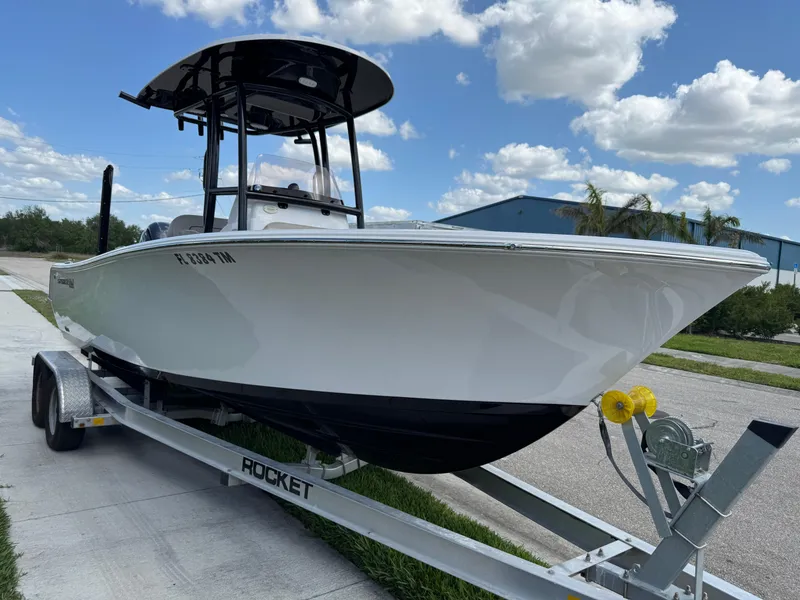 Slide: The Image of 2023 Sportsman Open 212 Center Console boat on trailer, parked outdoors under blue sky. - 28