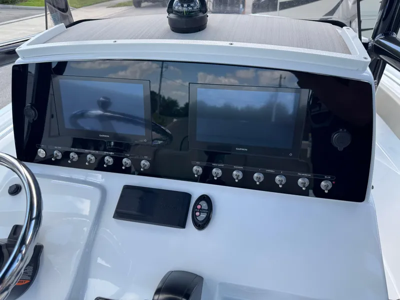 Slide: The Image of 2023 Sportsman Open 212 Center Console dashboard with dual screens and controls. - 35