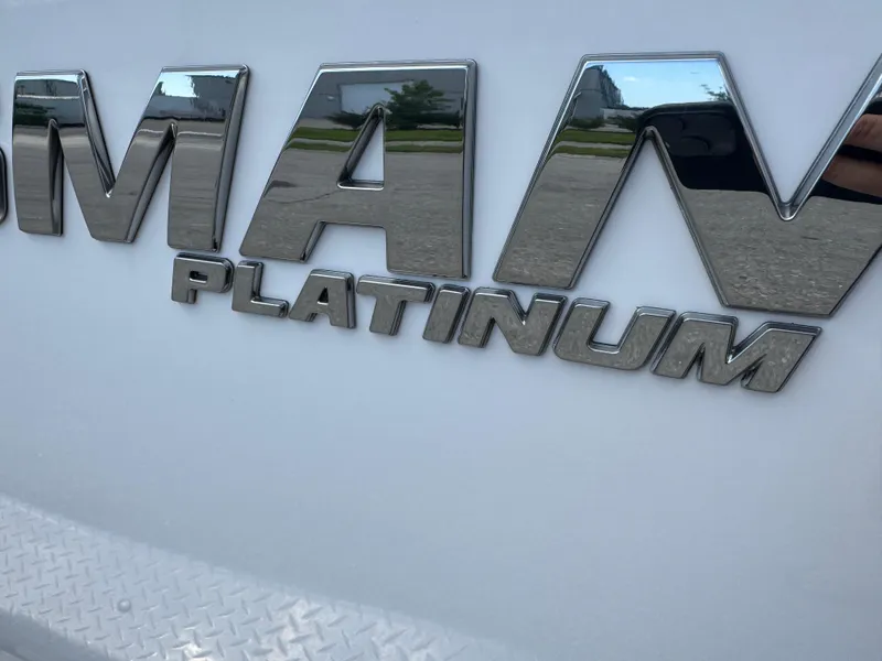 Slide: The Image of 2023 Sportsman Open 212 Center Console, chrome 'Platinum' emblem detail. - 4