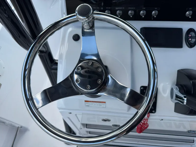 Slide: The Image of Steering wheel of 2023 Sportsman Open 212 Center Console boat, featuring sleek chrome design. - 40