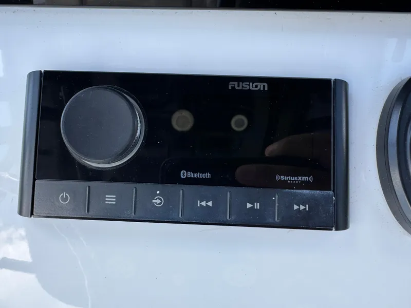 Slide: The Image of Fusion audio control panel on 2023 Sportsman Open 212 Center Console boat. - 42