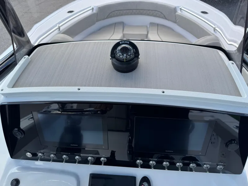 Slide: The Image of 2023 Sportsman Open 212 Center Console dashboard with dual screens and compass. - 43