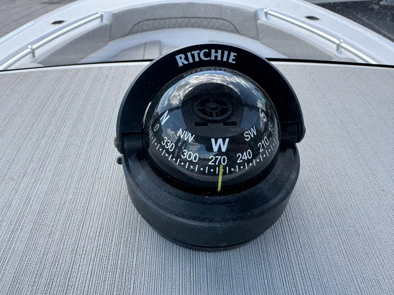 Slide: The Image of Compass on 2023 Sportsman Open 212 Center Console boat dashboard. - 44