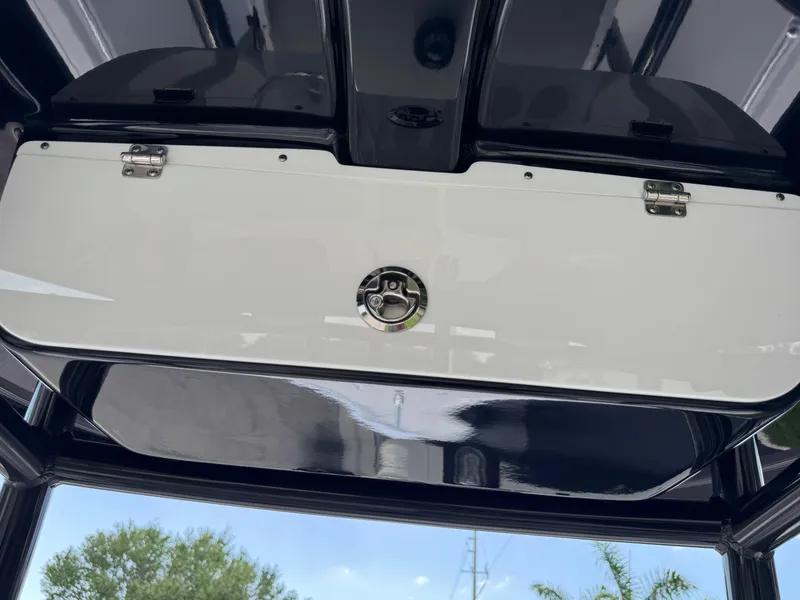 Slide: The Image of 2023 Sportsman Open 212 Center Console storage compartment, sleek design, outdoor view. - 46