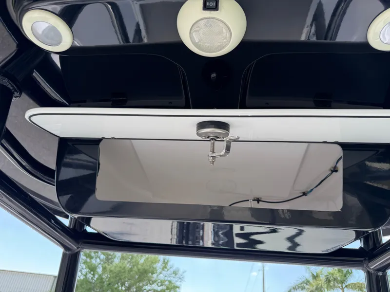 Slide: The Image of 2023 Sportsman Open 212 Center Console boat interior with overhead storage and lighting. - 49