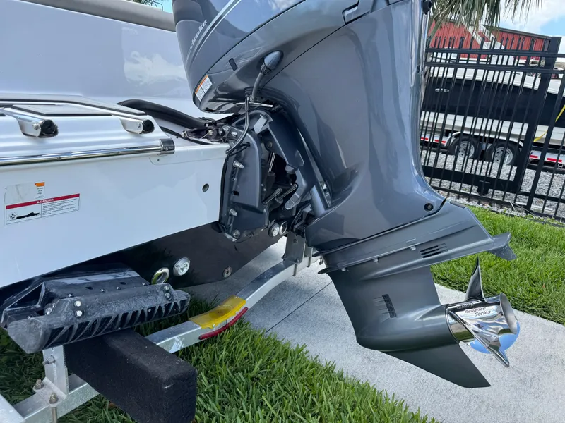Slide: The Image of 2023 Sportsman Open 212 Center Console boat engine on trailer, close-up view. - 7