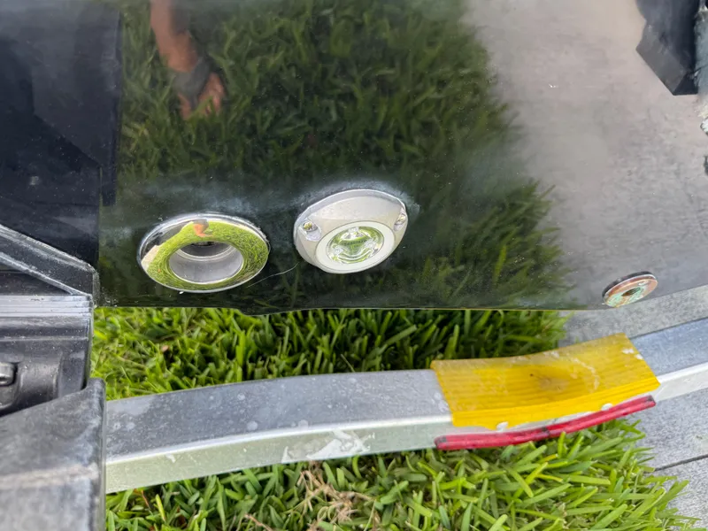 Slide: The Image of 2023 Sportsman Open 212 Center Console boat detail with trailer on grass. - 9