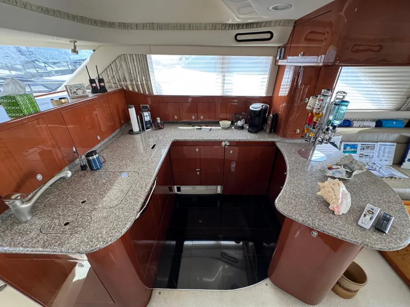 Slide: The Image of Luxurious kitchen interior of 2004 Sea Ray 560 Sedan Bridge yacht with granite countertops. - 10