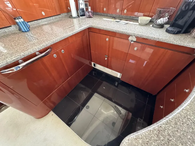 Slide: The Image of Luxurious kitchen area in 2004 Sea Ray 560 Sedan Bridge yacht with polished wood cabinets. - 12