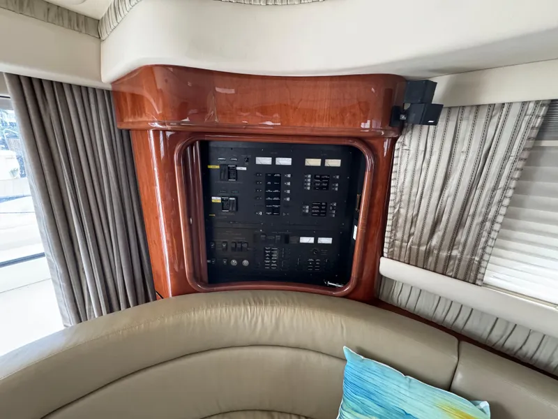 Slide: The Image of Electrical panel inside 2004 Sea Ray 560 Sedan Bridge yacht with wood finish and seating area. - 15