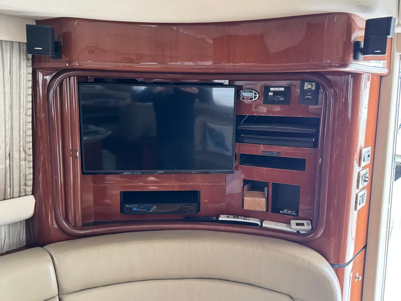 Slide: The Image of 2004 Sea Ray 560 Sedan Bridge interior with entertainment system and leather seating. - 16