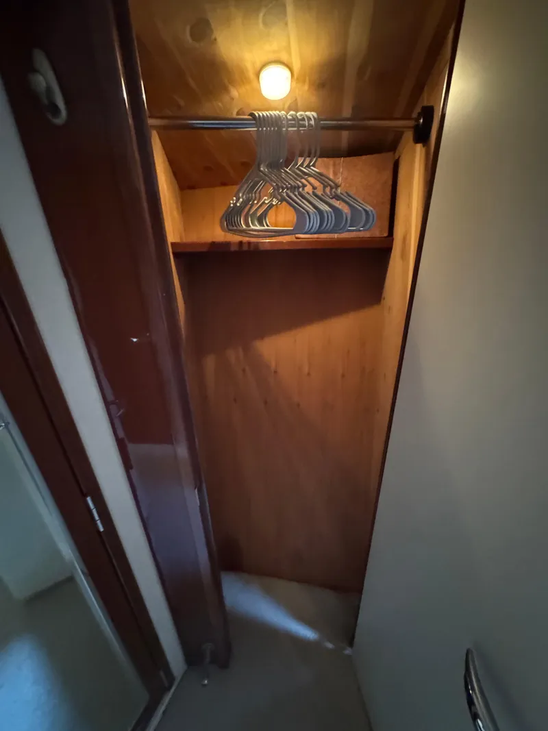 Slide: The Image of Wooden closet with hangers inside a 2004 Sea Ray 560 Sedan Bridge yacht. - 18