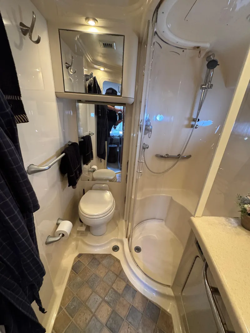 Slide: The Image of 2004 Sea Ray 560 Sedan Bridge bathroom with shower, toilet, and mirror. - 19