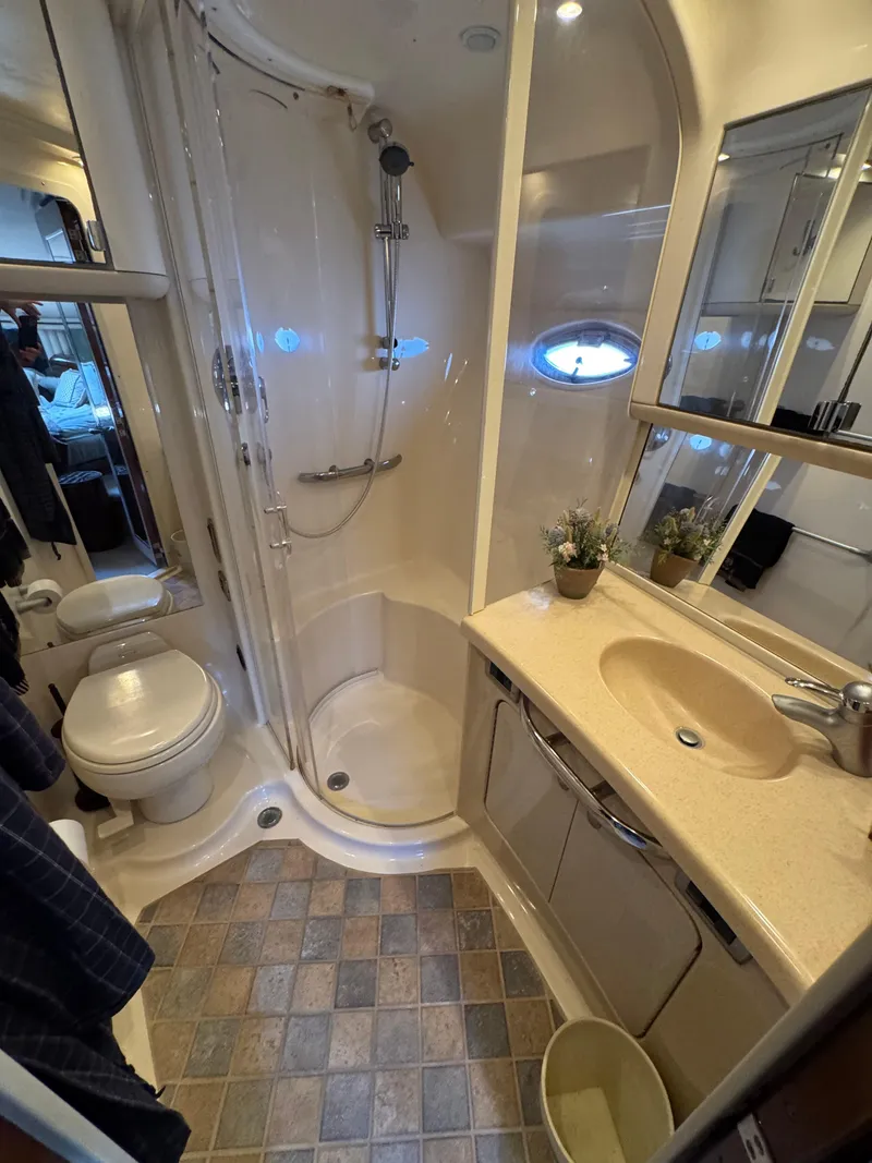 Slide: The Image of Bathroom interior of 2004 Sea Ray 560 Sedan Bridge yacht, featuring shower and vanity. - 20