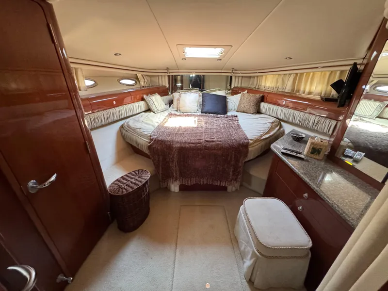 Slide: The Image of Luxurious 2004 Sea Ray 560 Sedan Bridge yacht bedroom with elegant decor and plush bedding. - 21