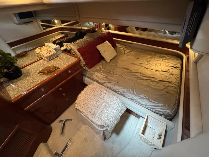 Slide: The Image of Luxurious 2004 Sea Ray 560 Sedan Bridge cabin with cozy bed and elegant decor. - 26