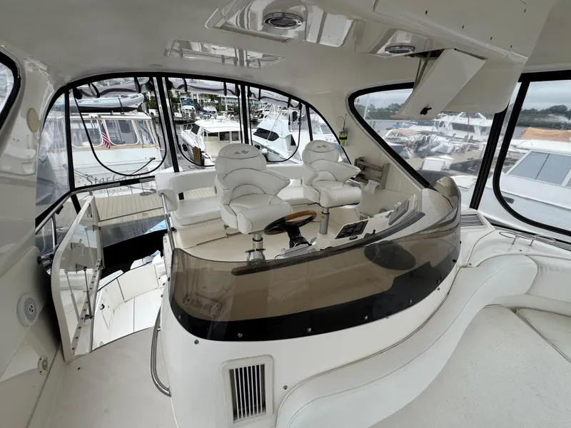 Slide: The Image of Luxurious 2004 Sea Ray 560 Sedan Bridge yacht interior with helm and seating area. - 33