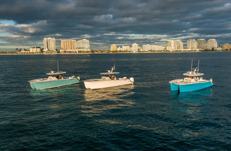 Slide: The Image of Three HammerCat 35 yachts on water with city skyline in background, 2025 model. - 19