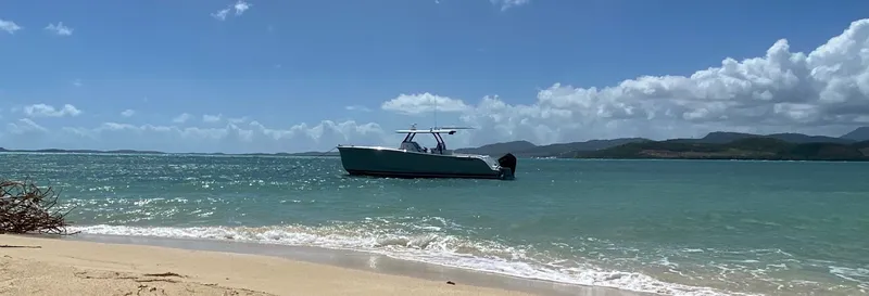 Slide: The Image of 2025 Hammer Yachts HammerCat 35 on turquoise sea near sandy beach. - 20