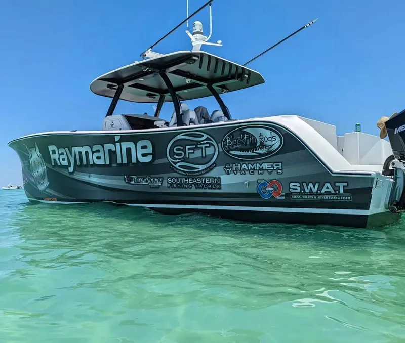 Slide: The Image of 2025 Hammer Yachts HammerCat 35 in clear water, featuring sponsor logos and sleek design. - 3