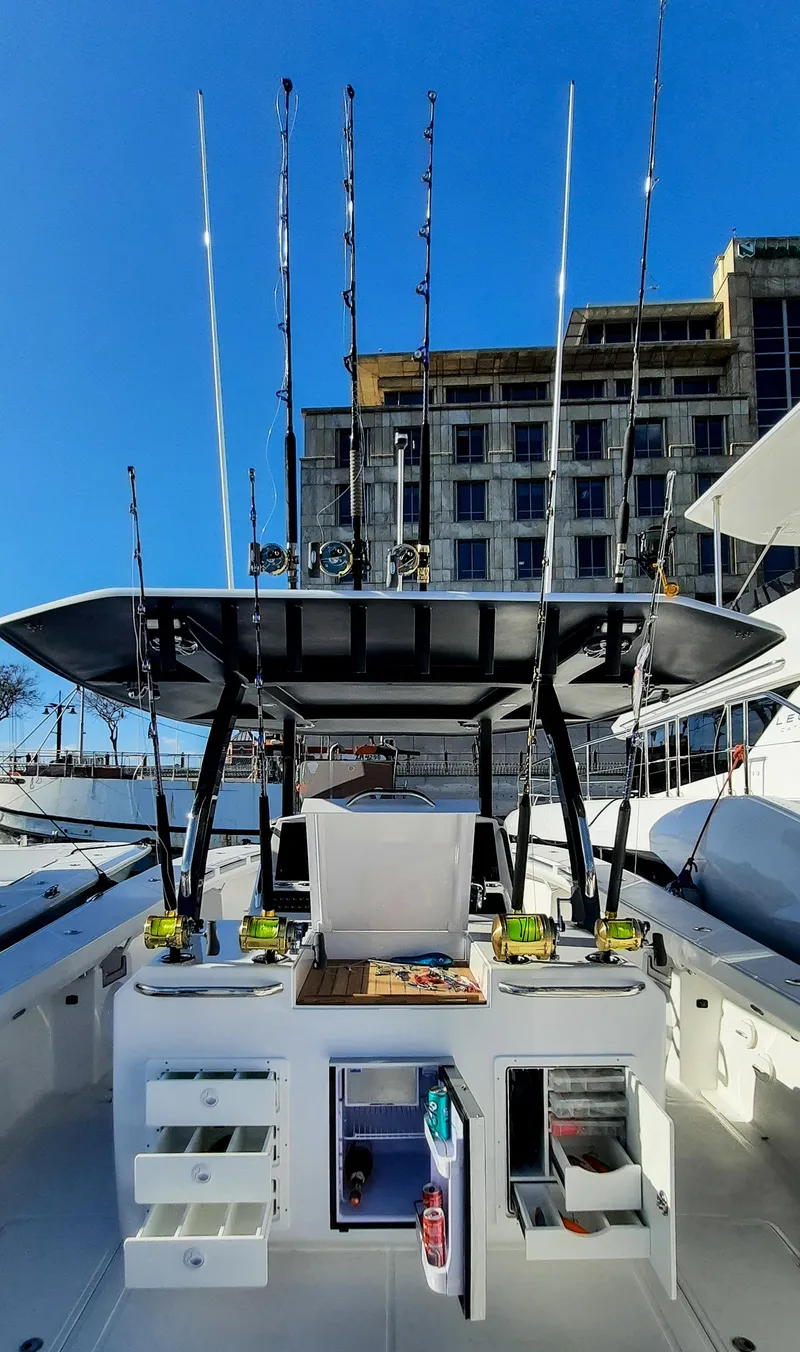 Slide: The Image of 2025 Hammer Yachts HammerCat 35 with fishing gear, docked under clear blue sky. - 11