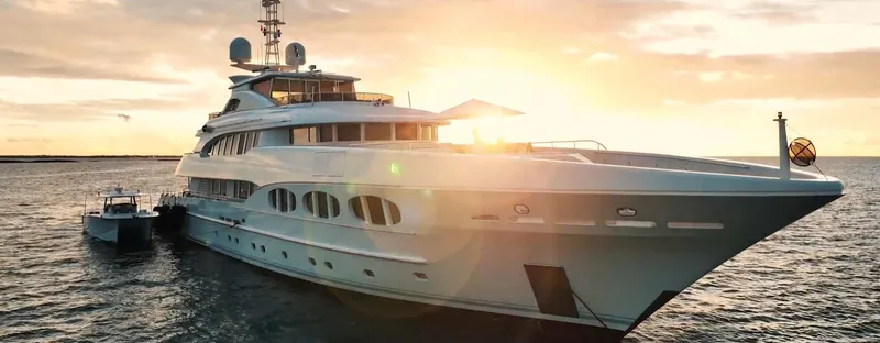 Slide: The Image of Luxurious Hammer Yachts HammerCat 35, 2025 model, sailing at sunset on open water. - 13