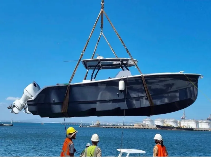 Slide: The Image of 2025 Hammer Yachts HammerCat 35 being lifted by crane at a harbor. - 4
