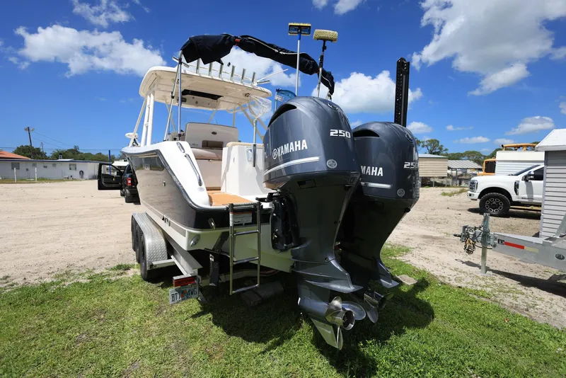 Slide: The Image of 2015 Pursuit S 280 Sport boat with twin Yamaha 250 engines on a trailer. - 1
