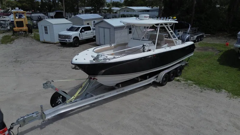 Slide: The Image of 2015 Pursuit S 280 Sport boat on a trailer in a storage yard. - 12