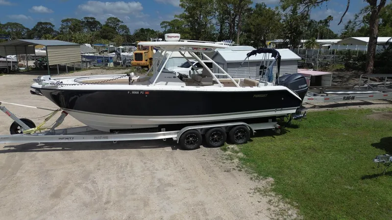 Slide: The Image of 2015 Pursuit S 280 Sport boat on trailer in outdoor storage area. - 13