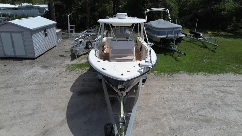 Slide: The Image of 2015 Pursuit S 280 Sport boat on trailer, parked outdoors. - 15