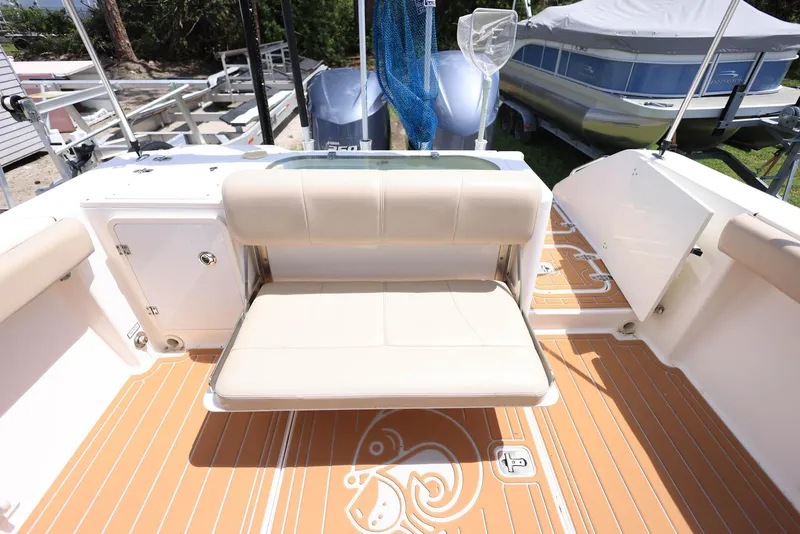 Slide: The Image of 2015 Pursuit S 280 Sport boat with beige seating and teak-style flooring. - 16
