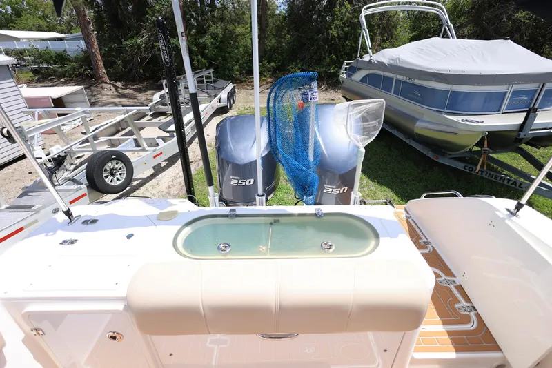 Slide: The Image of 2015 Pursuit S 280 Sport boat with dual 250 engines, docked near other boats. - 17