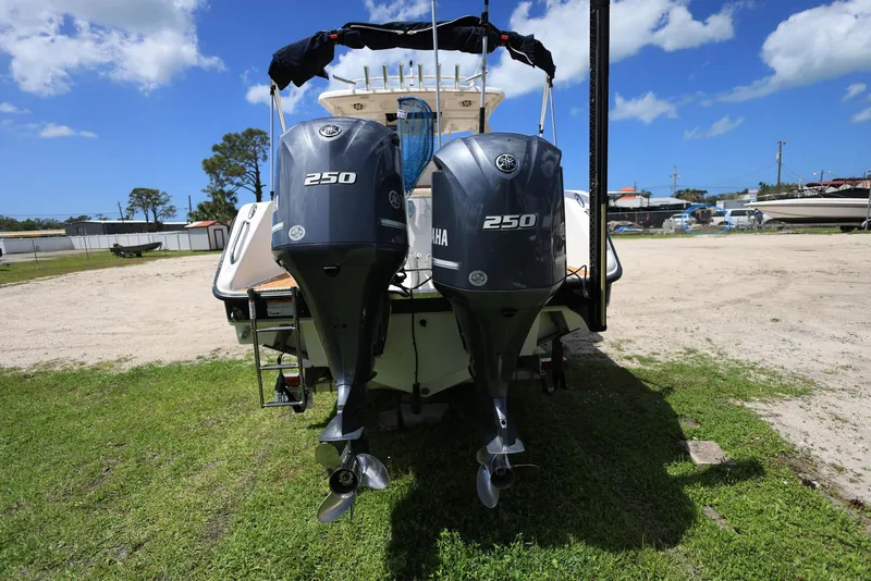 Slide: The Image of 2015 Pursuit S 280 Sport boat with twin Yamaha 250 engines on grassy area. - 2
