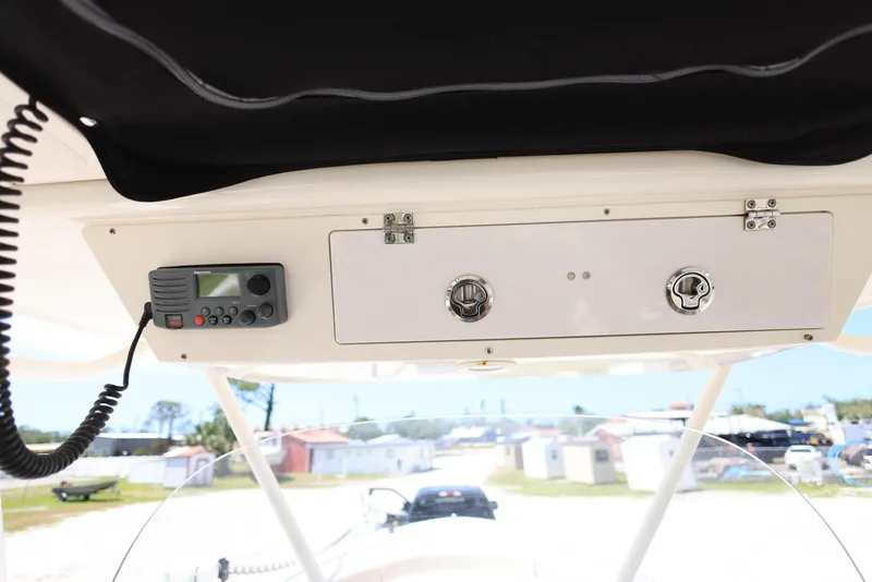 Slide: The Image of 2015 Pursuit S 280 Sport boat console with radio and storage compartment. - 27
