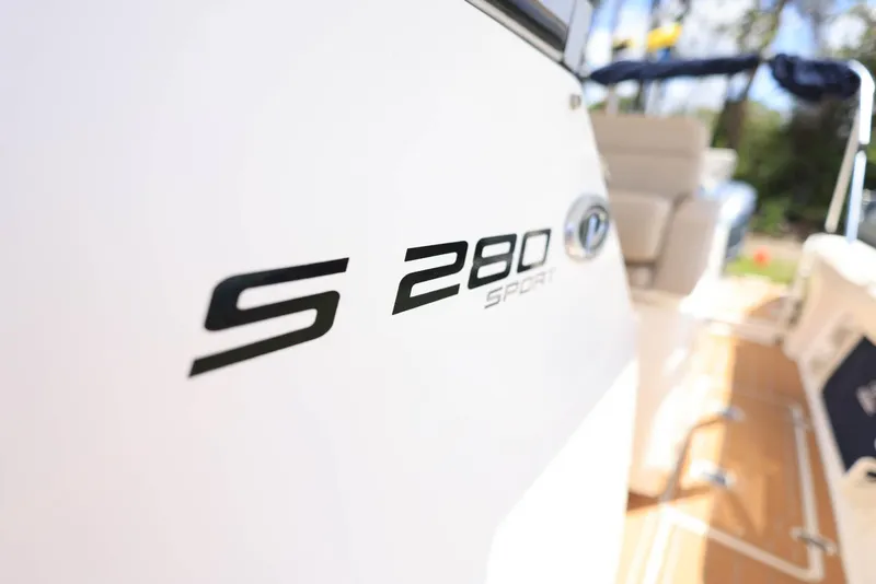 Slide: The Image of 2015 Pursuit S 280 Sport boat, close-up of model name on hull. - 28